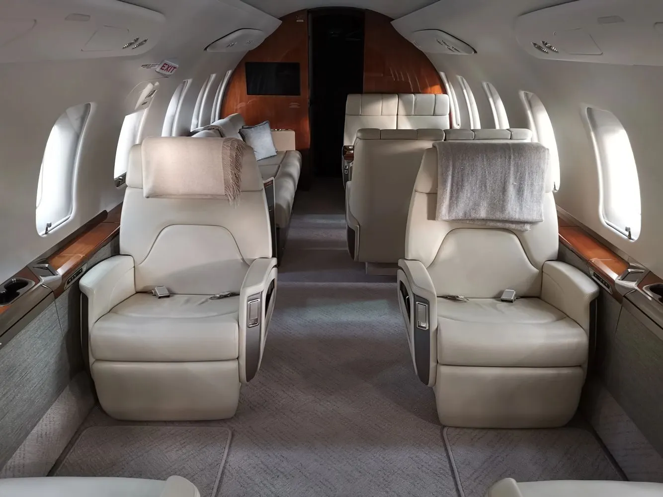 Business jet club seating in white leather with polished veneer